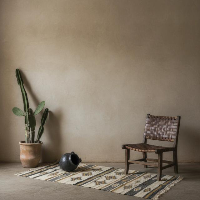 Eclectic room with a woven leather chair