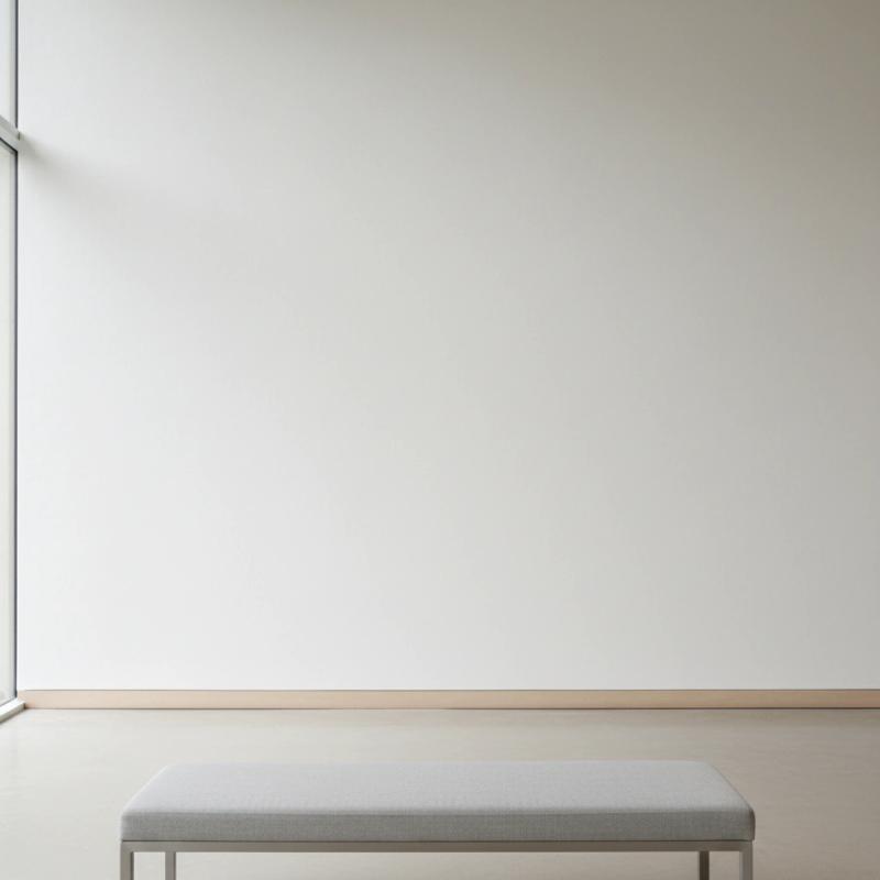 Minimalist gallery with a window and grey bench