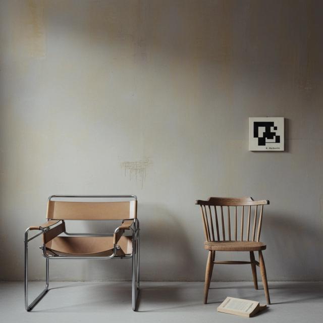 Contemporary room with two chairs and a small artwork