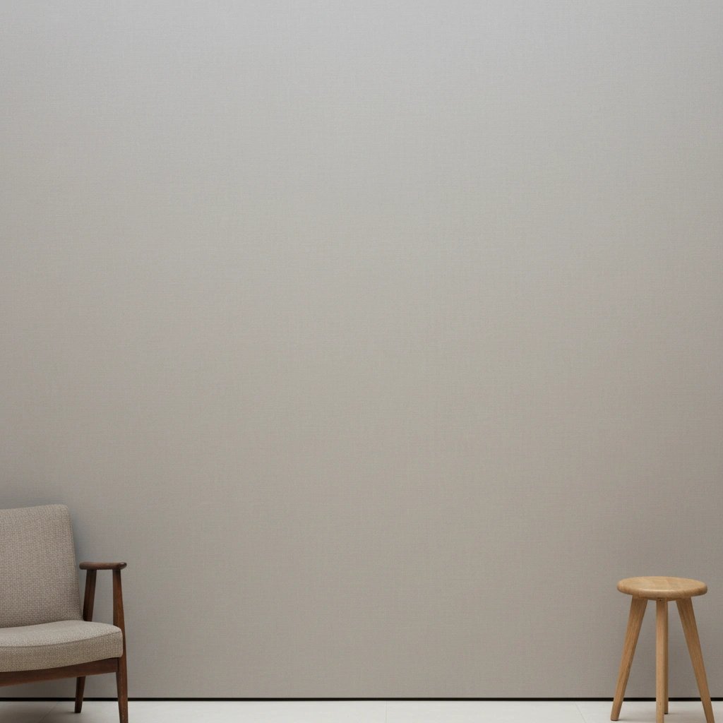 Wall art mockup: Minimalist gallery with an armchair and a wooden stool