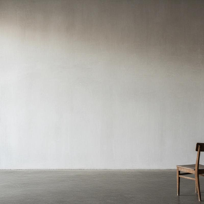 Minimalist gallery with a single wooden chair