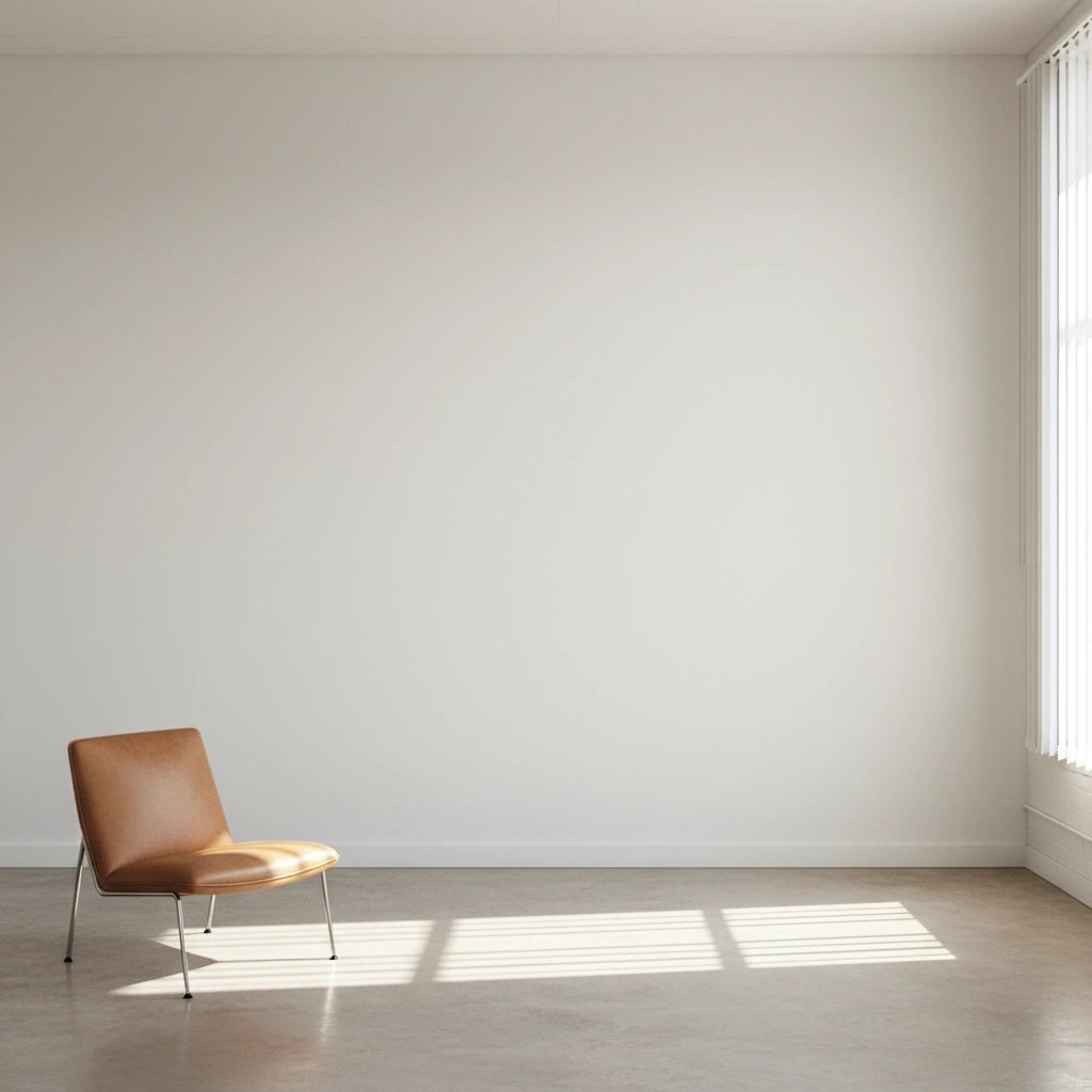 Wall art mockup: Minimalist white-cube gallery with a brown leather chair