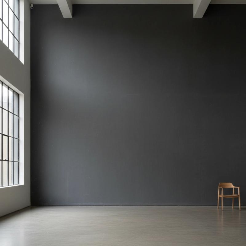 Minimalist gallery with dark grey walls and large windows