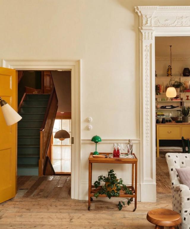 Eclectic hallway with a bar cart and plant