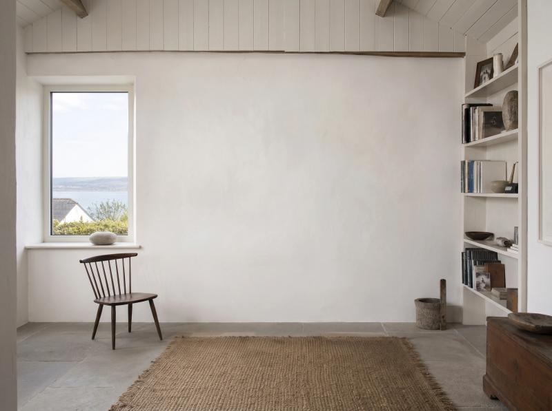 Bright contemporary room with a window and a wooden chair