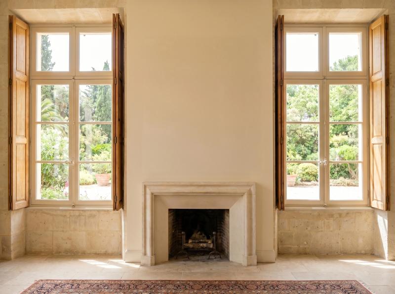 Grand room with a stone fireplace and large windows