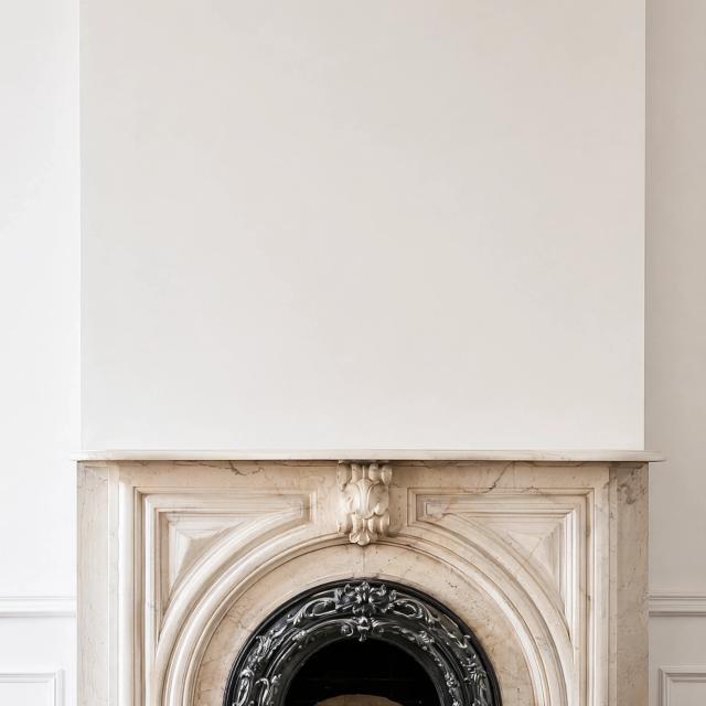 Grand room with a white wall and marble fireplace