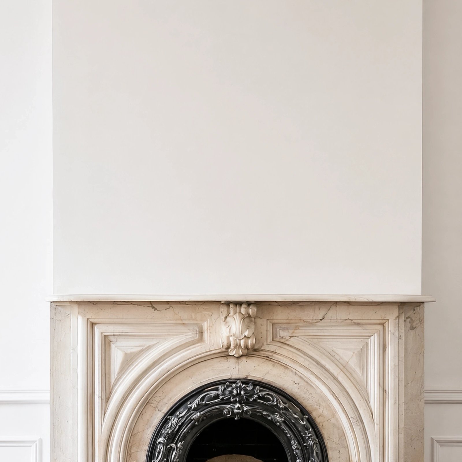 Wall art mockup: Grand room with a white wall and marble fireplace, with a fireplace