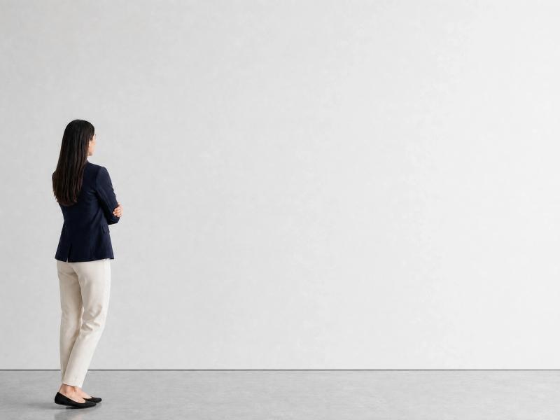 White-cube gallery with a visitor looking at the wall