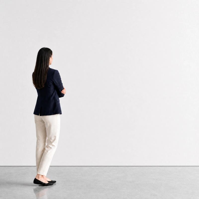 White-cube gallery with a visitor looking at the wall