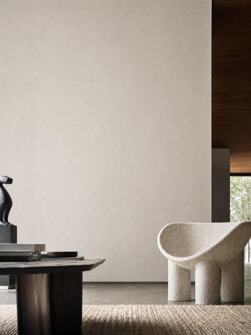 Contemporary living room with a textured wall and sculptural furniture