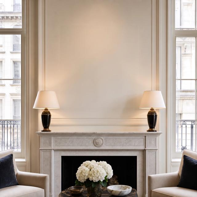 Grand room with a marble fireplace and tall windows