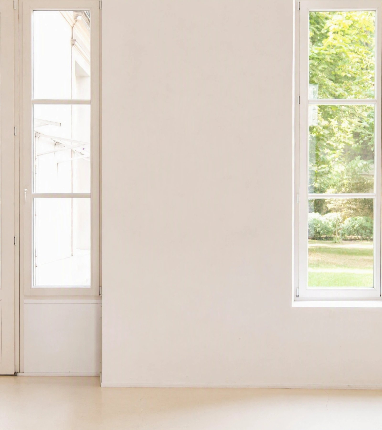 Wall art mockup: Bright gallery with white walls and tall windows, with a window
