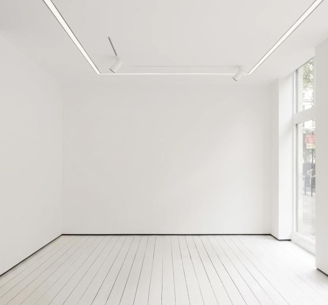 Minimalist gallery with white walls and track lighting