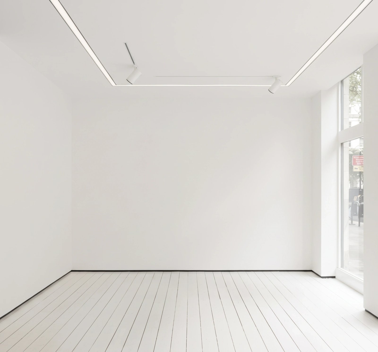 Wall art mockup: Minimalist gallery with white walls and track lighting