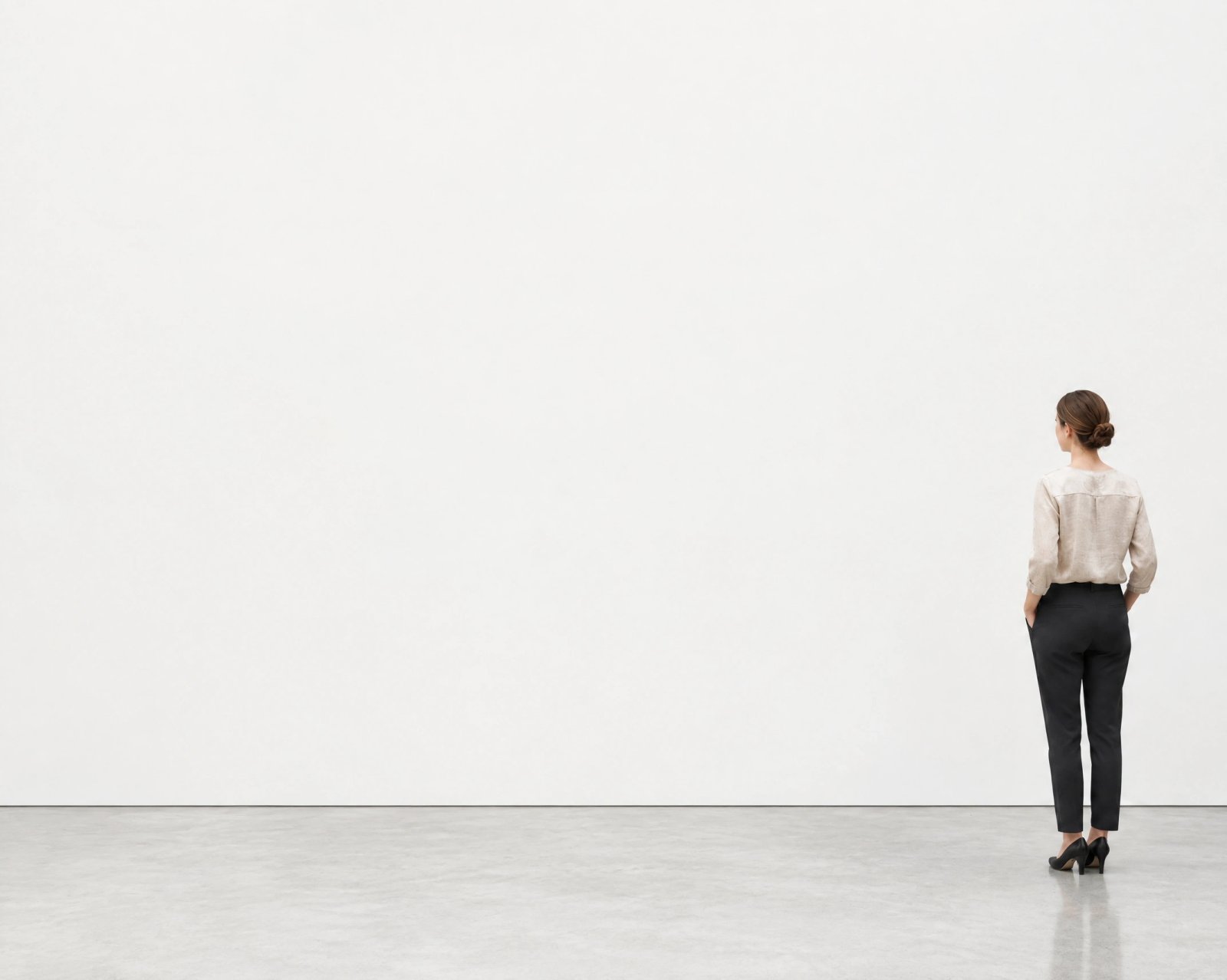 Wall art mockup: White-cube gallery with a person looking at the wall, with a person