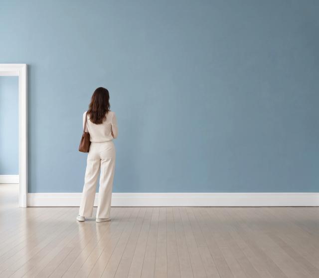 Empty gallery with a blue wall and a person