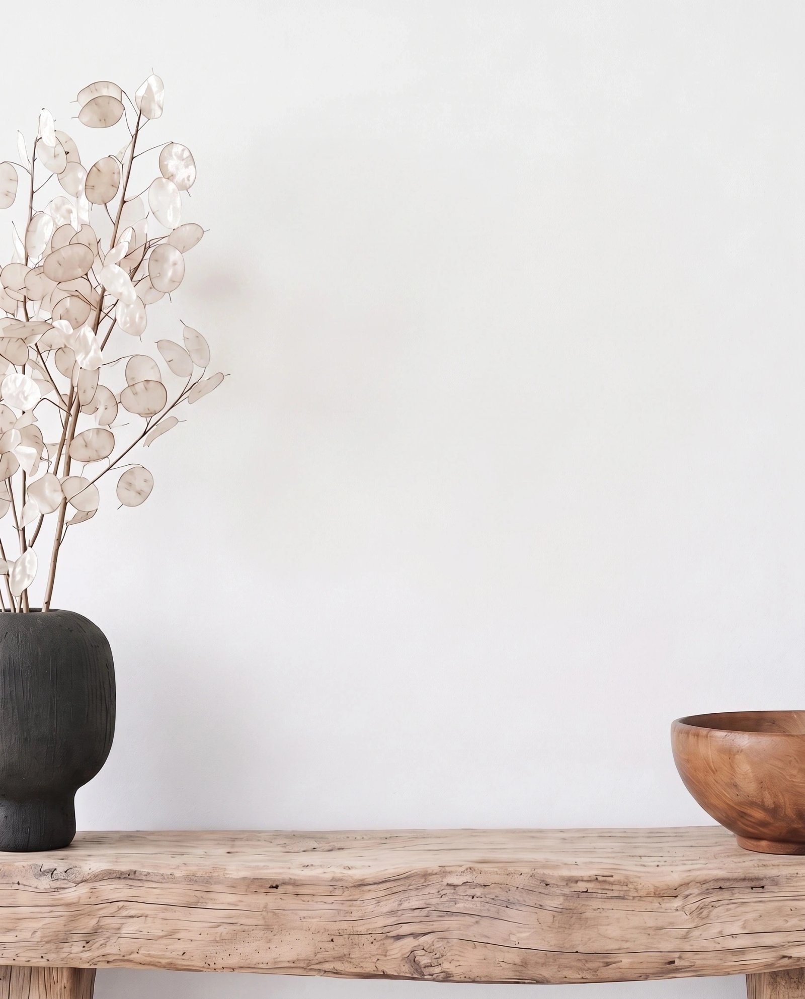 Wall art mockup: Contemporary room with a wooden bench and dried plants, with plants